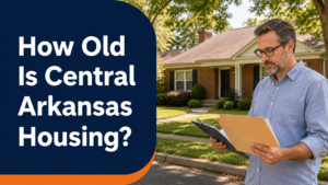 Central Arkansas homeowner reviewing property records outside an older brick house